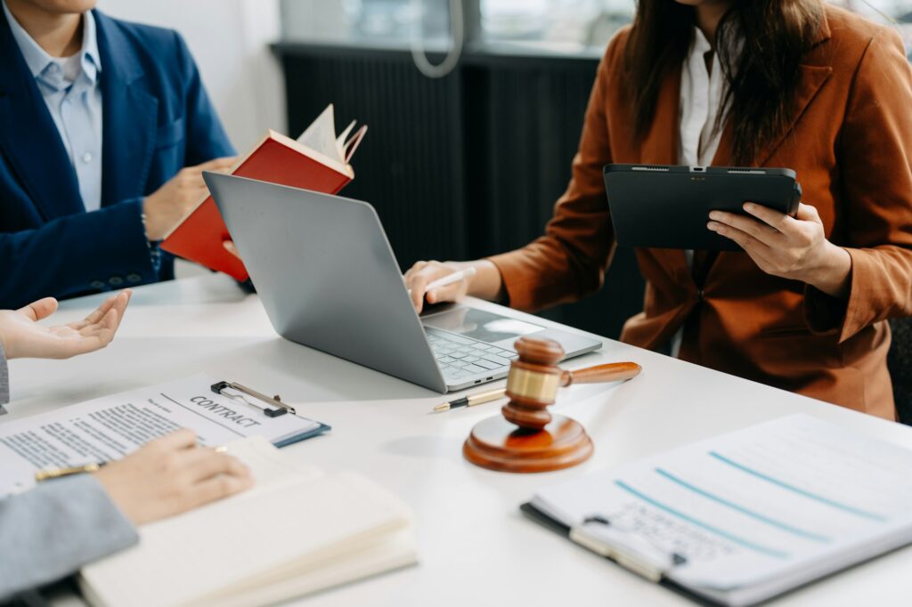 Business people and lawyers discussing contract papers sitting at the table. Cape Girardeau Missouri Personal Injury lawyer.